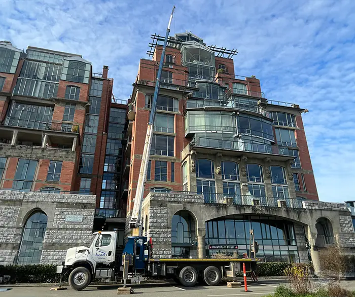 Crane truck in front of a historic apartment building