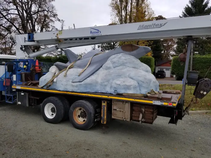 Boom truck carrying a tarped load