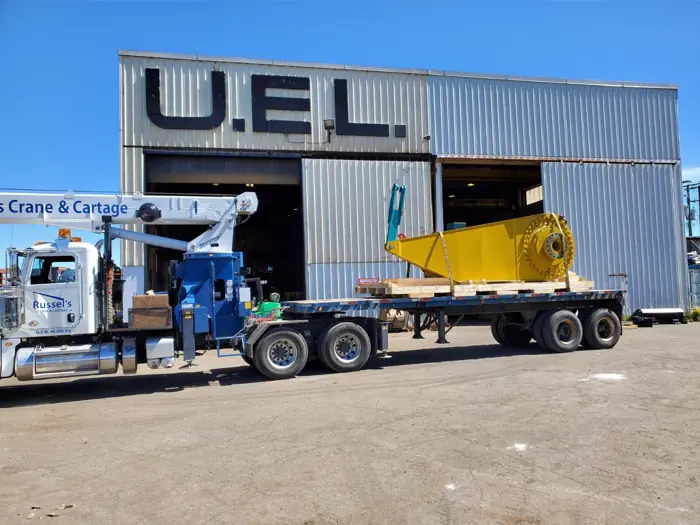 Crane truck loading at an industrial building