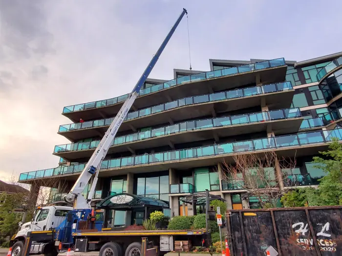 Crane placing materials at a multi-storey building site