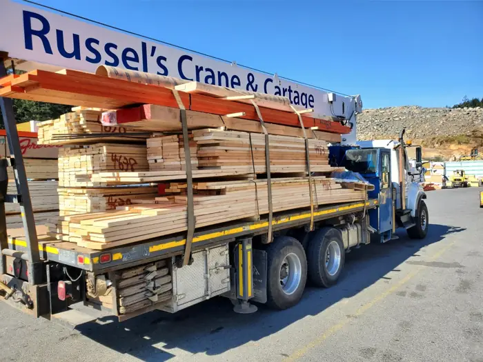 Truck loaded with lumber marked Russel's Crane & Cartage