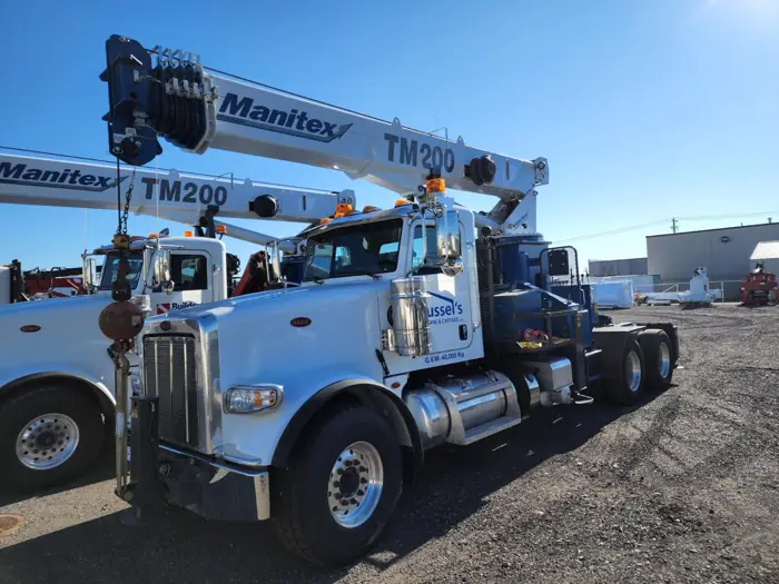 Crane truck set up for a lift at a commercial site