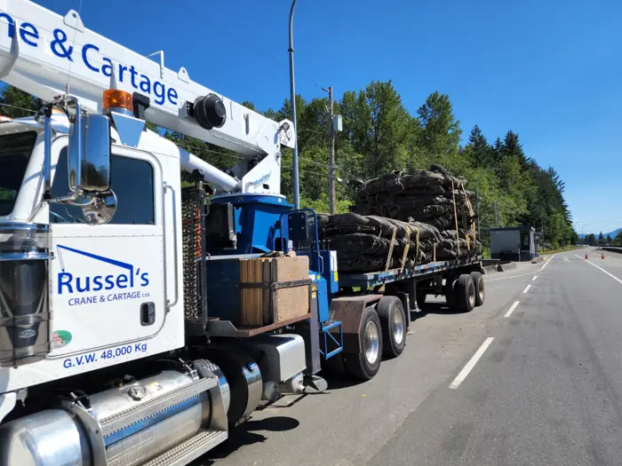 Russel's crane truck on a roadside delivery