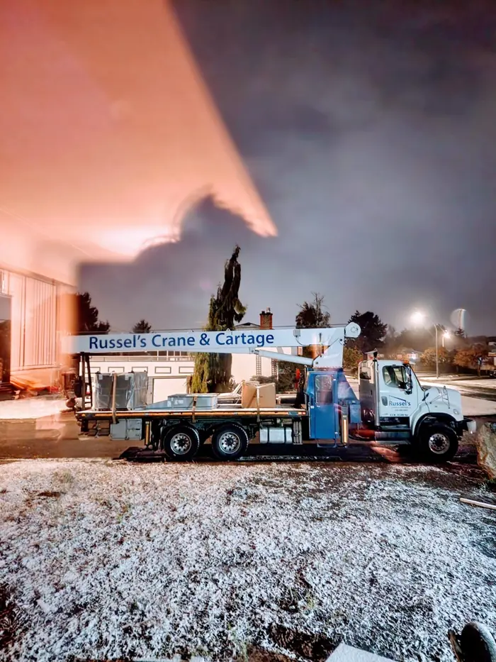 Crane truck working at night in the snow