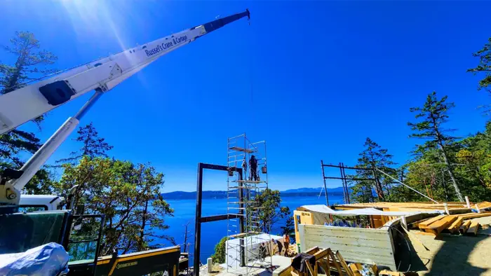 Crane boom reaching over a waterfront job