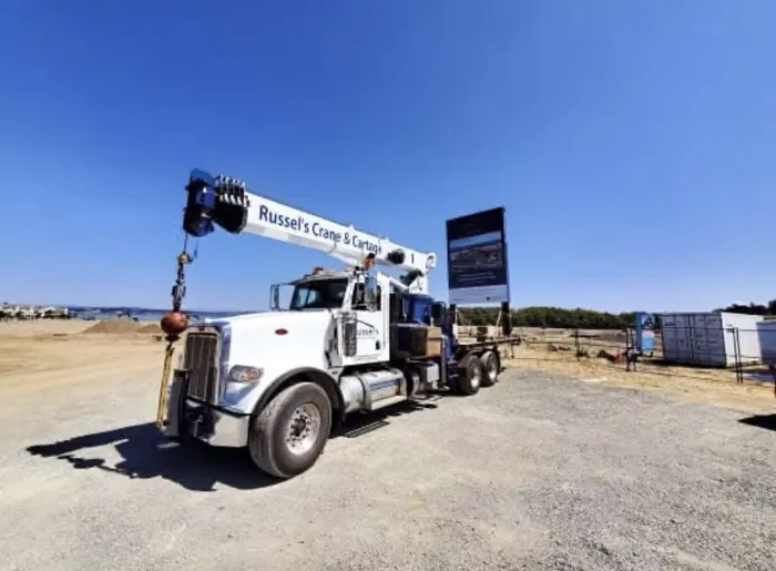 Peterbilt crane truck set up at a sunny job site