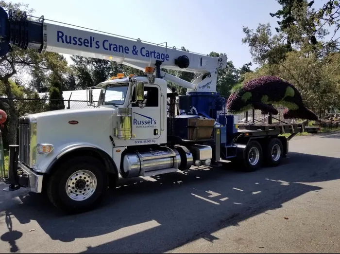 Russel's Crane & Cartage Peterbilt crane truck hauling a large orca topiary
