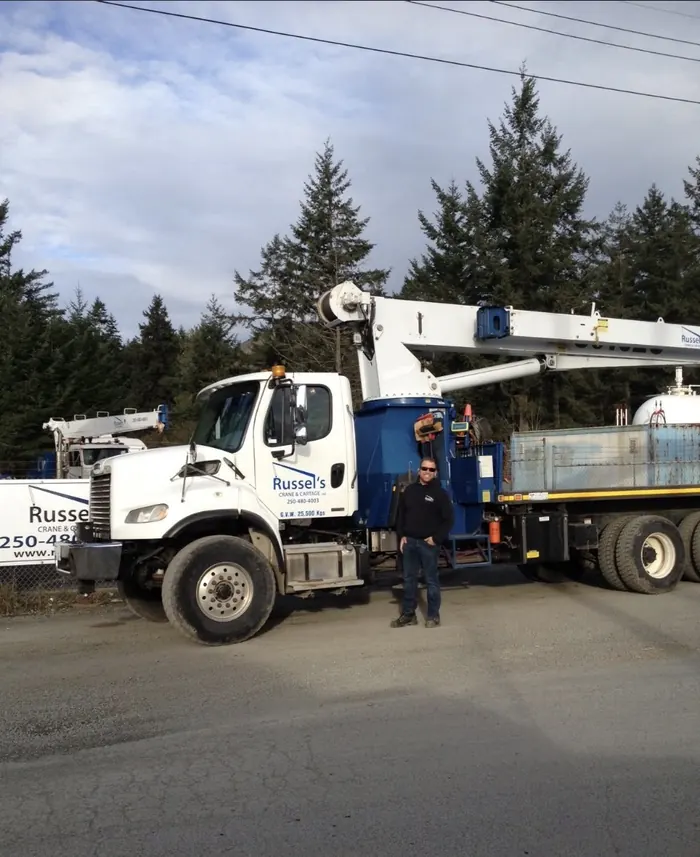 Russel's Crane & Cartage team member with a crane truck at the yard