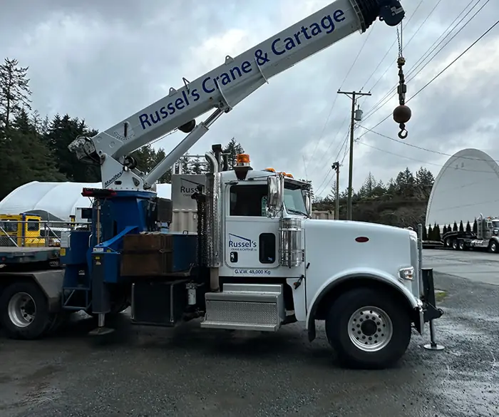 Russel's boom truck on a job site with crane extended
